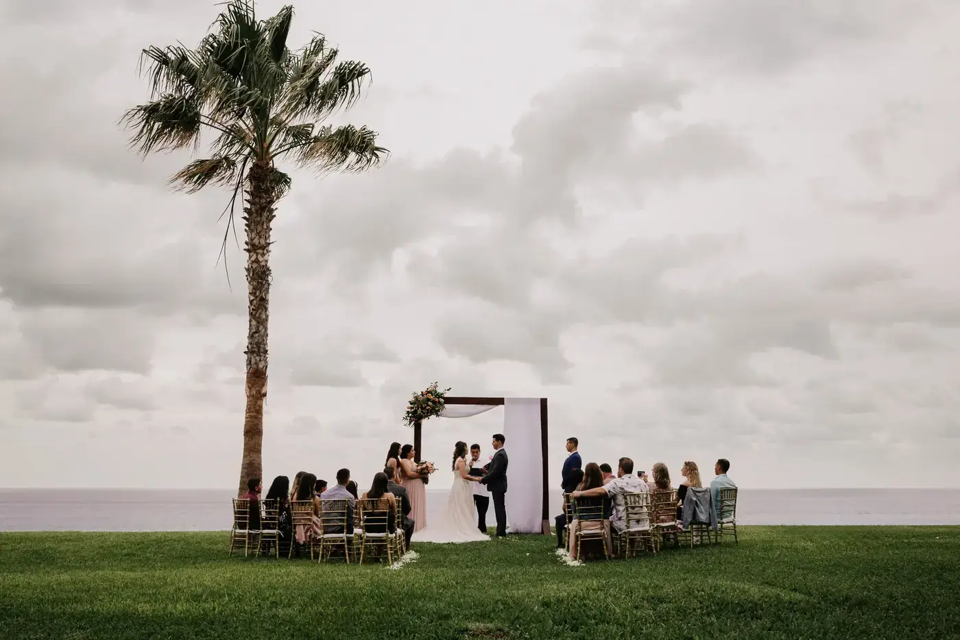 Couple exchanging vows at a wedding ceremony in Cabo San Lucas by Ana Badillo Photography