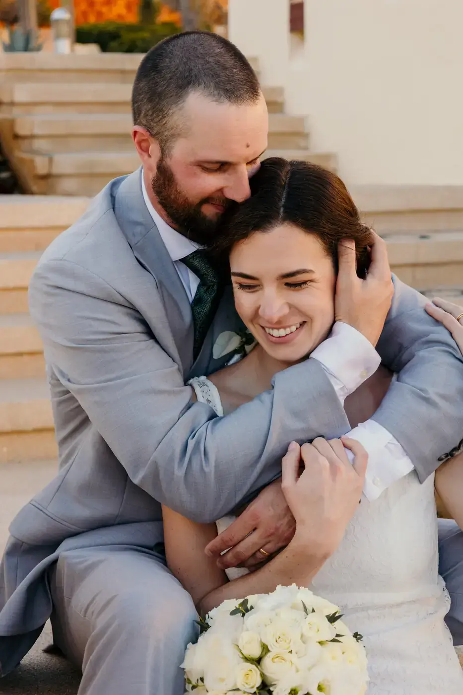 Couple embracing and laughing during couples session in Los Cabos