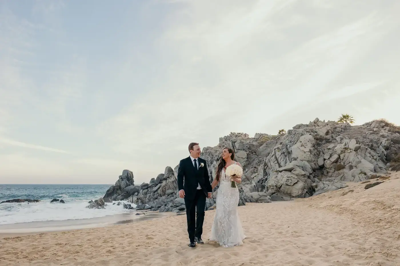 Couple walking the cliffs during a Cabo San Lucas elopement