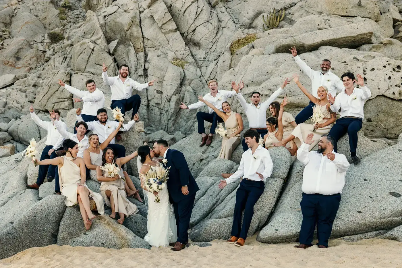 Wedding group photo on the rocks at a Cabo beach