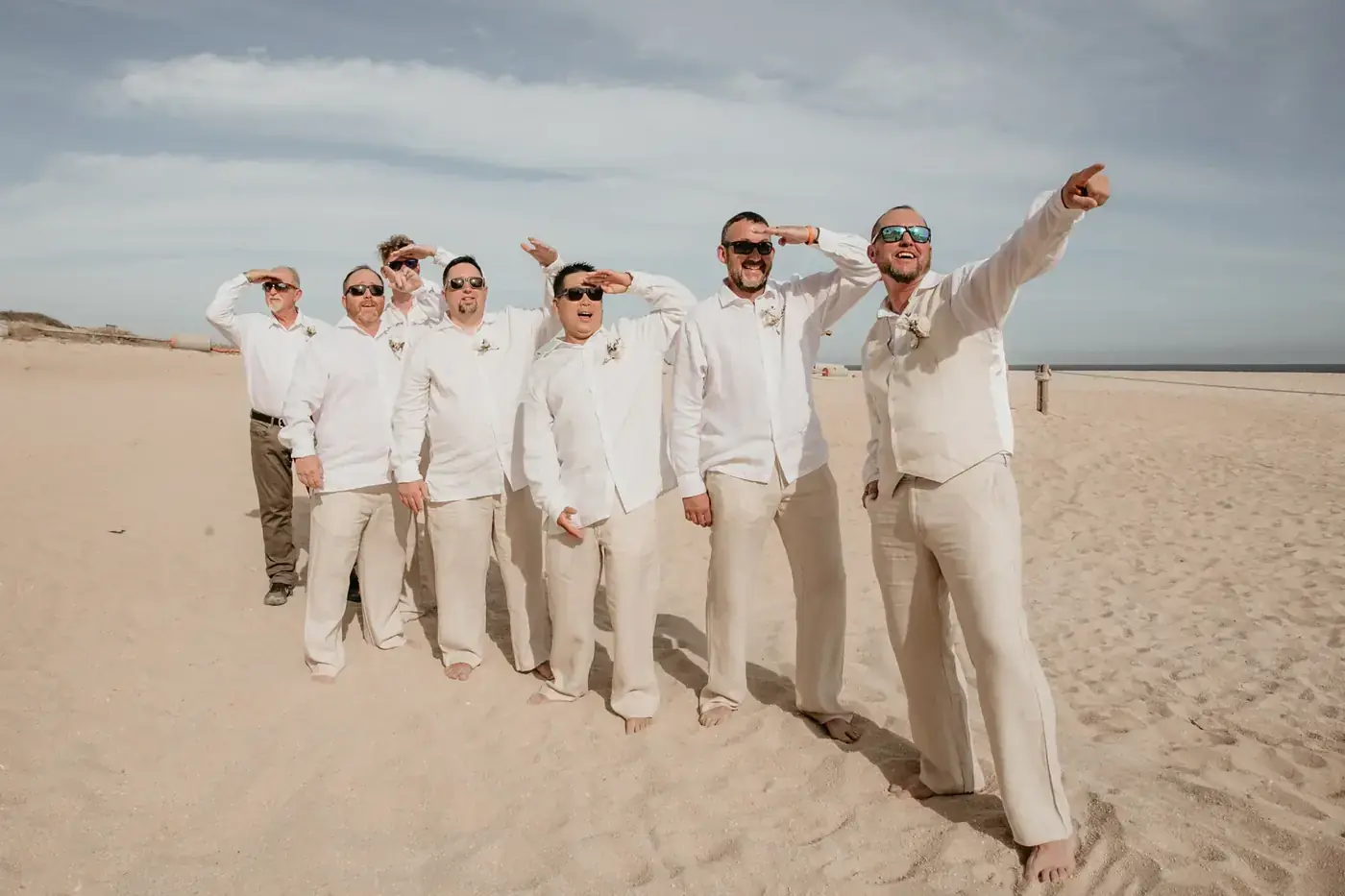 Groomsmen celebrating on the beach at a Cabo San Lucas wedding