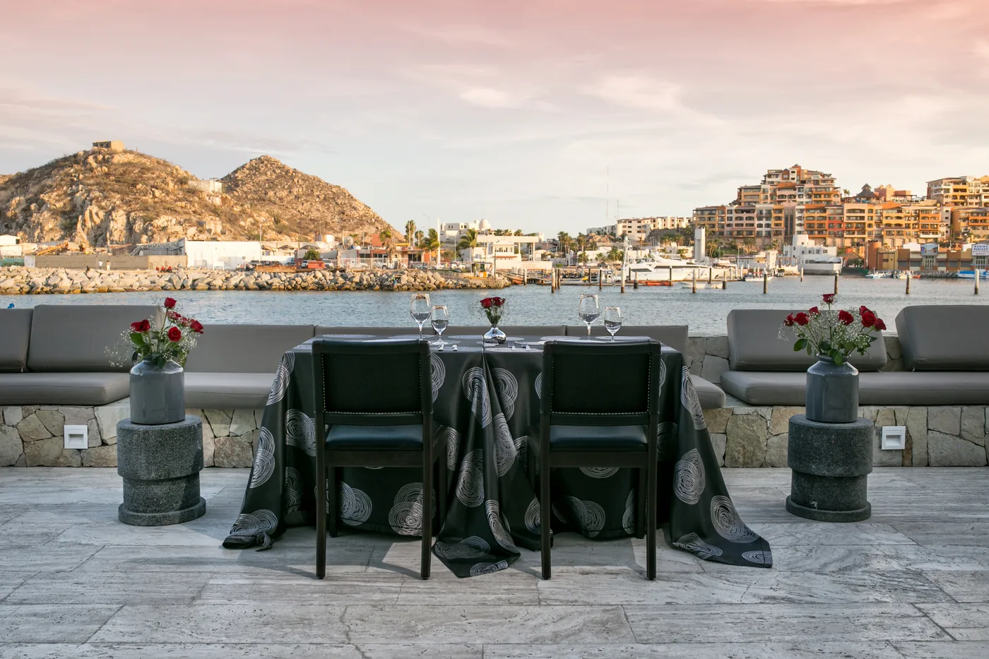 Rooftop dinner table with views of Land's End at Breathless Cabo San Lucas