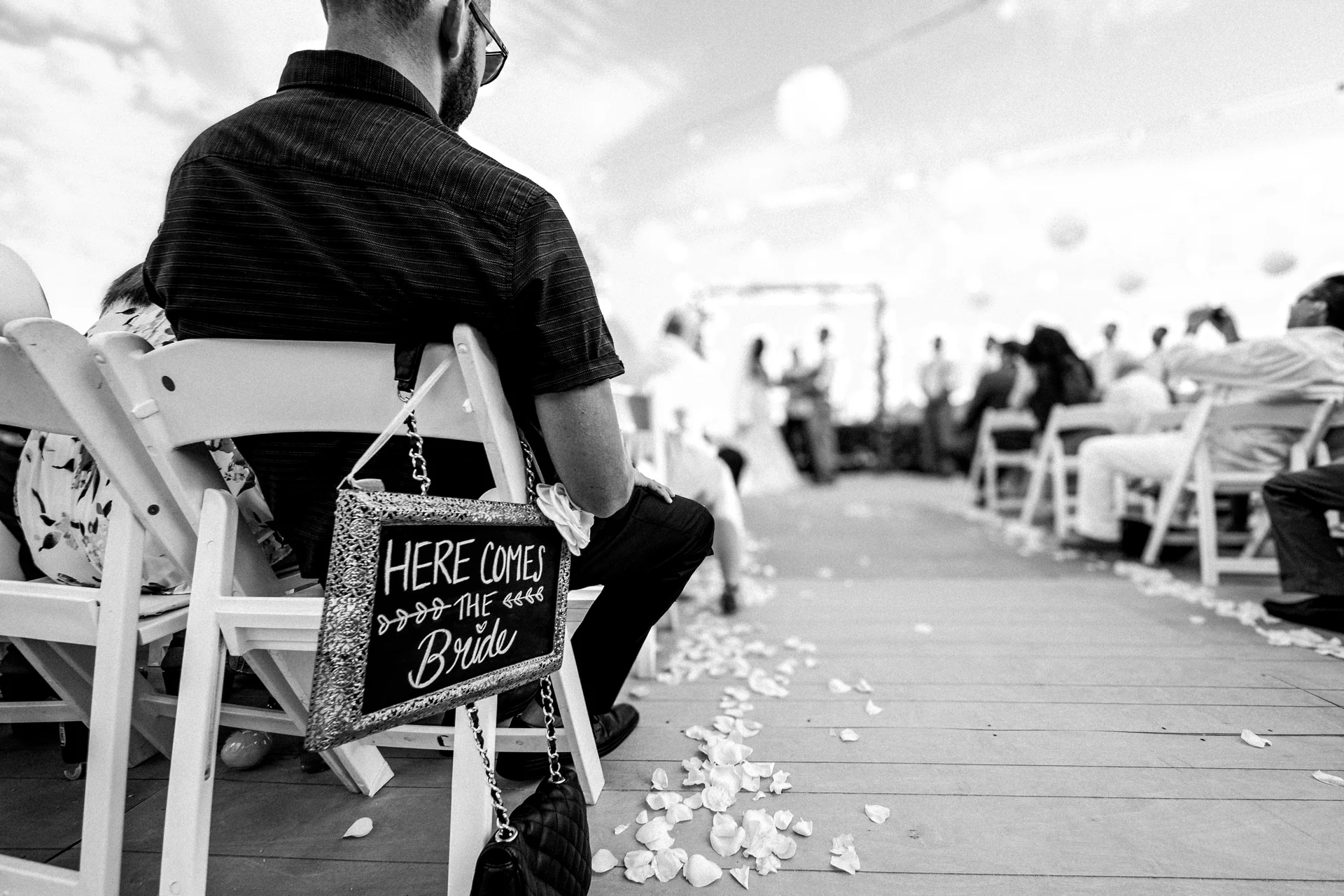 Here comes the bride sign on the aisle at a Cabo San Lucas wedding