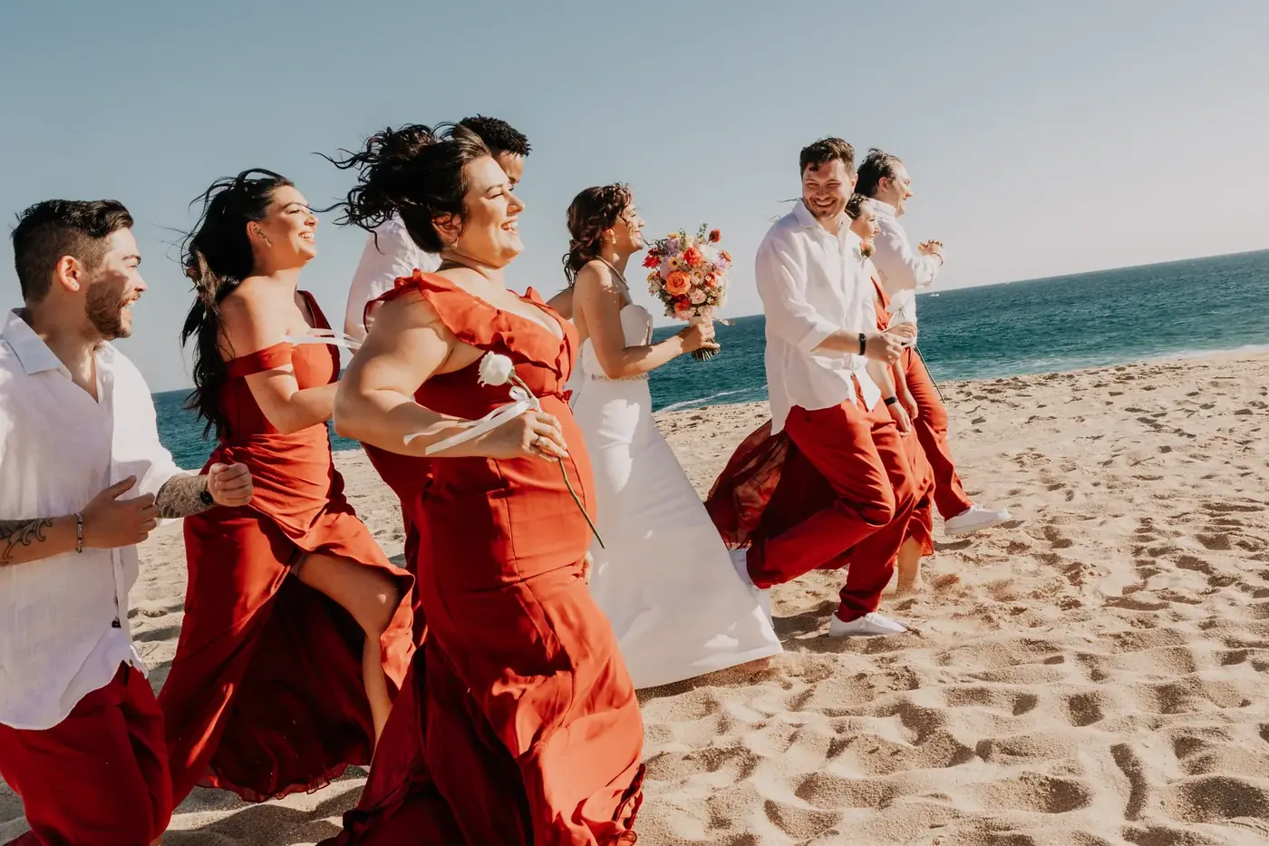 Bridal party in red dresses on the beach, Cabo San Lucas wedding