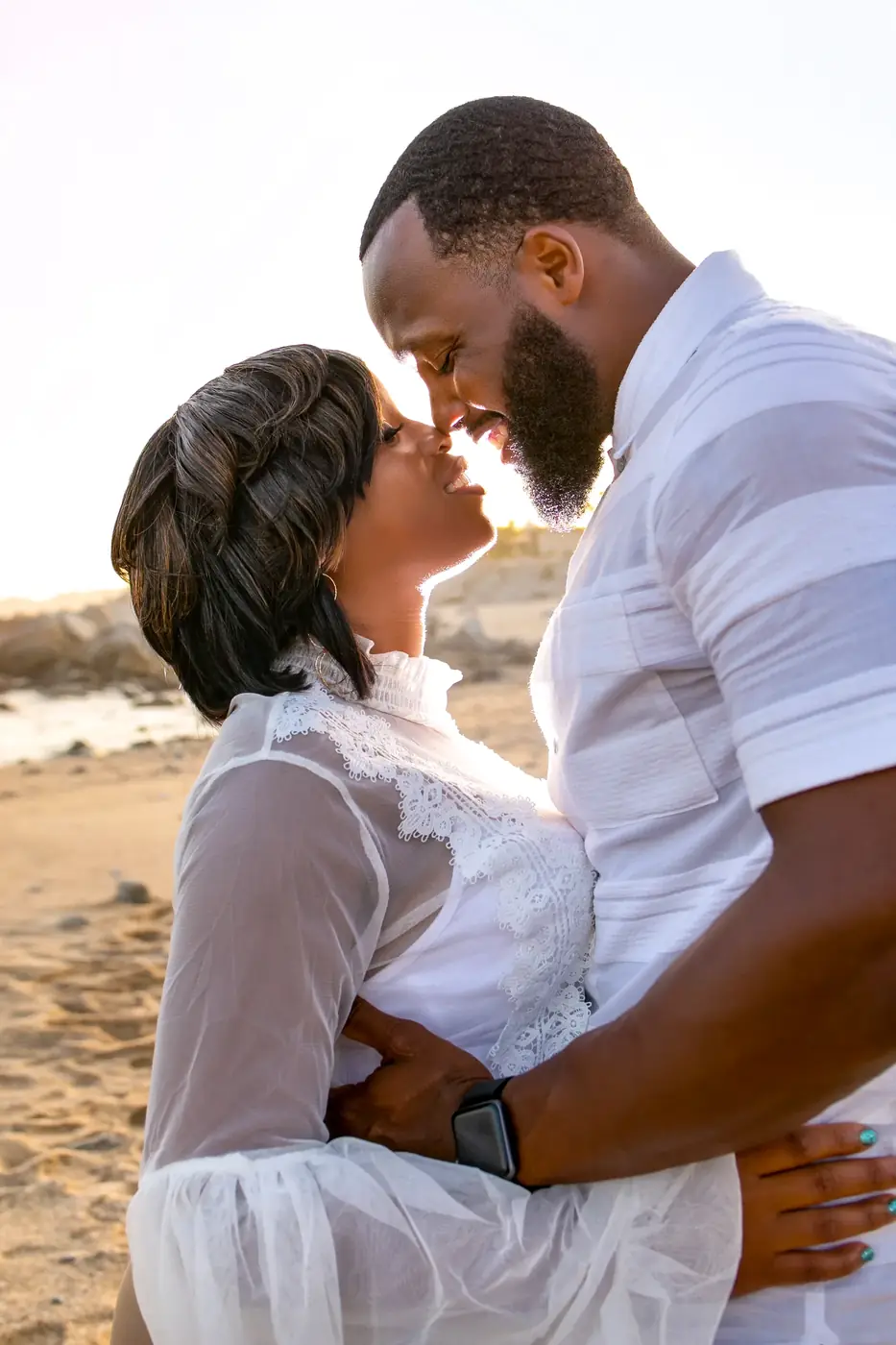 Couple forehead to forehead in golden light, Cabo couples session