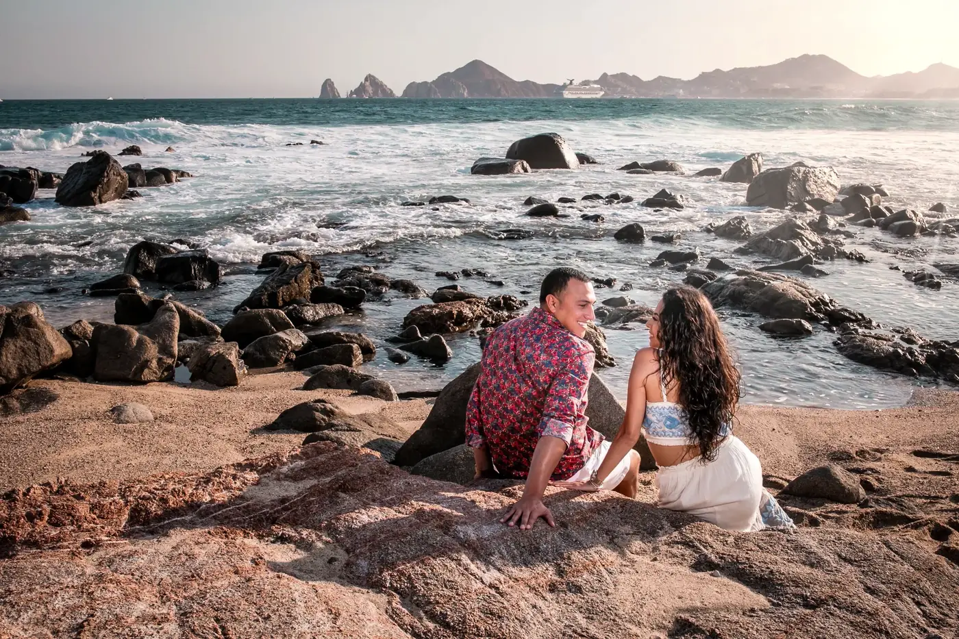 Couple on the rocks at sunset, Los Cabos engagement photography