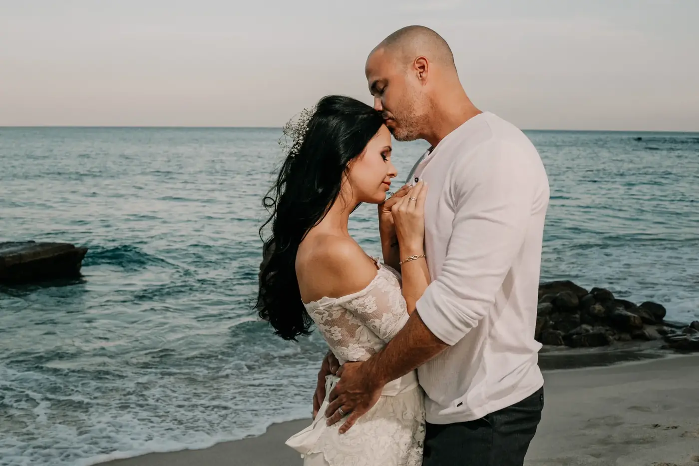 Bride and groom by the ocean in golden light, Cabo San Lucas wedding