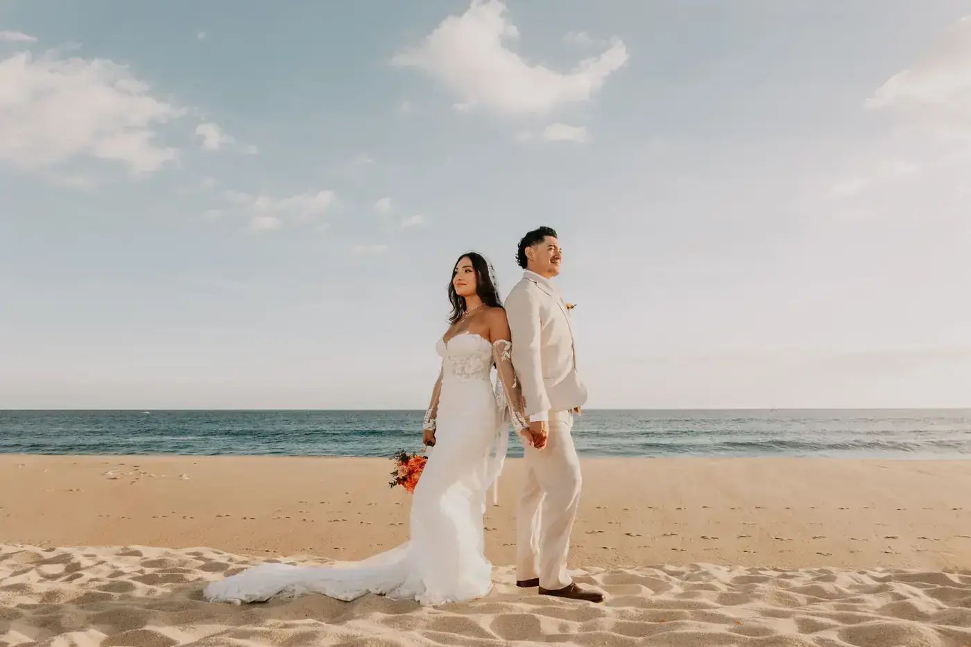 Bride and groom walking the calm beach on the Sea of Cortez side of Los Cabos