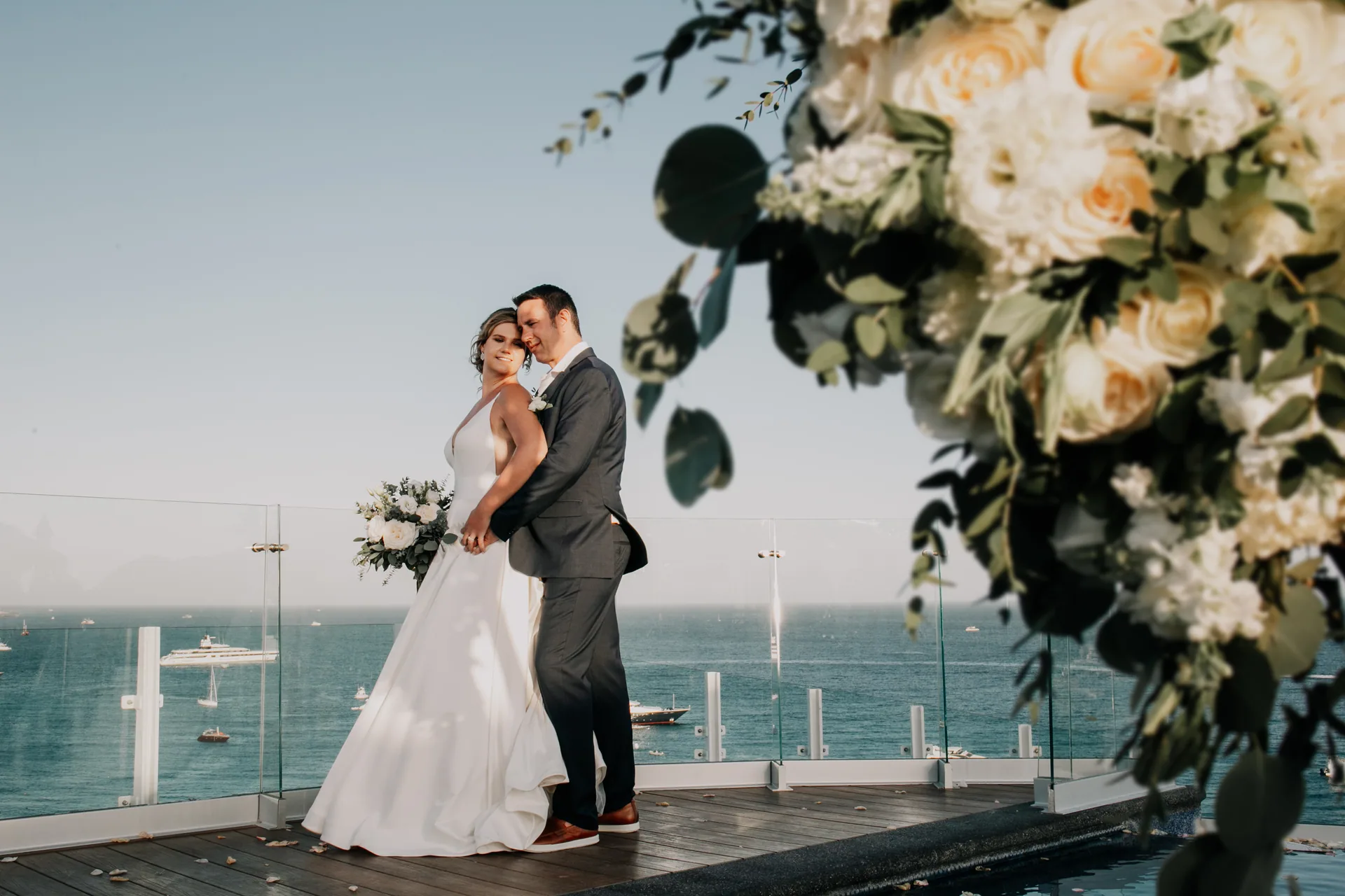 Newlyweds kissing on the beachfront at Corazón Cabo Resort & Spa