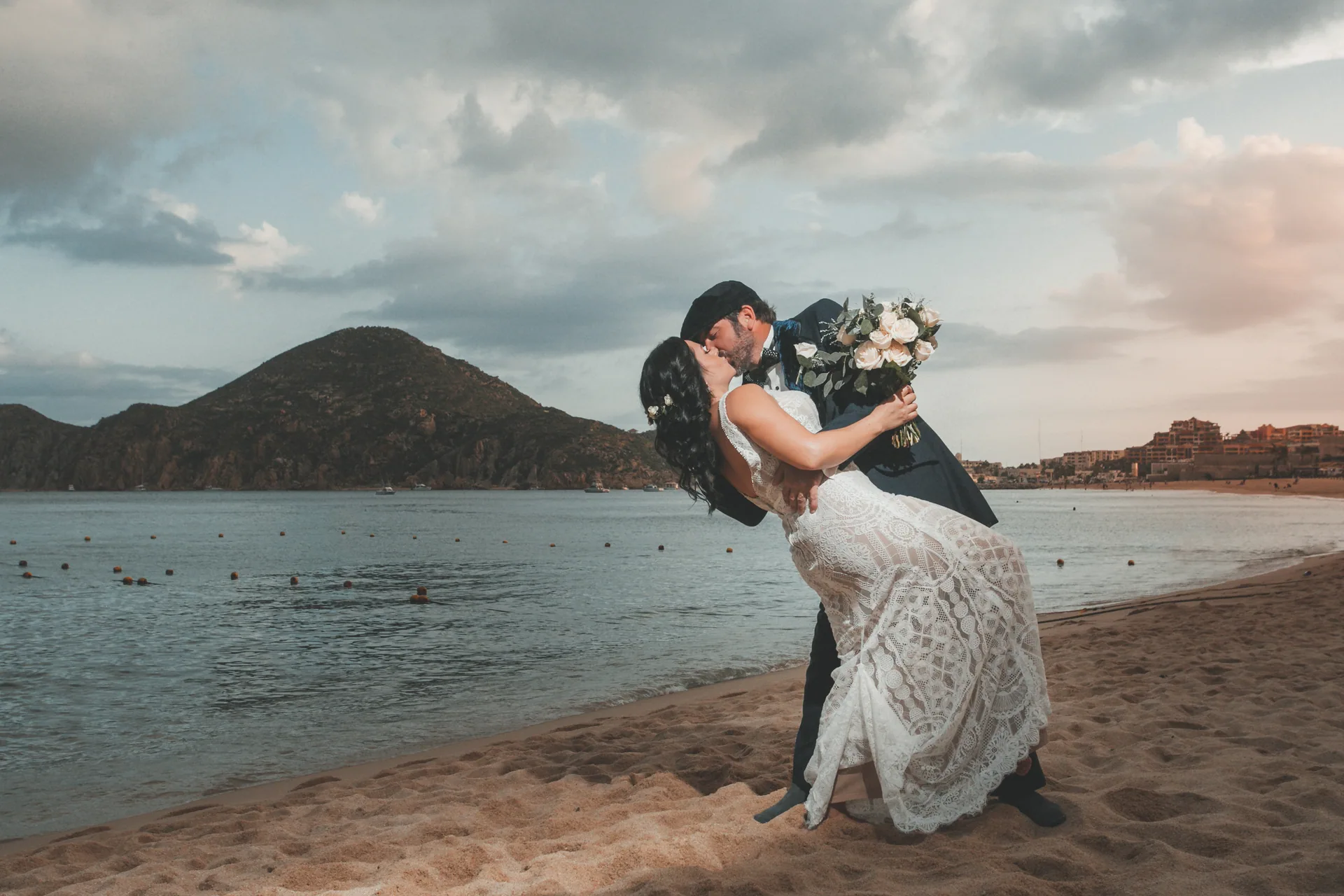 Bride and groom kissing on the beach at sunset, Cabo San Lucas wedding
