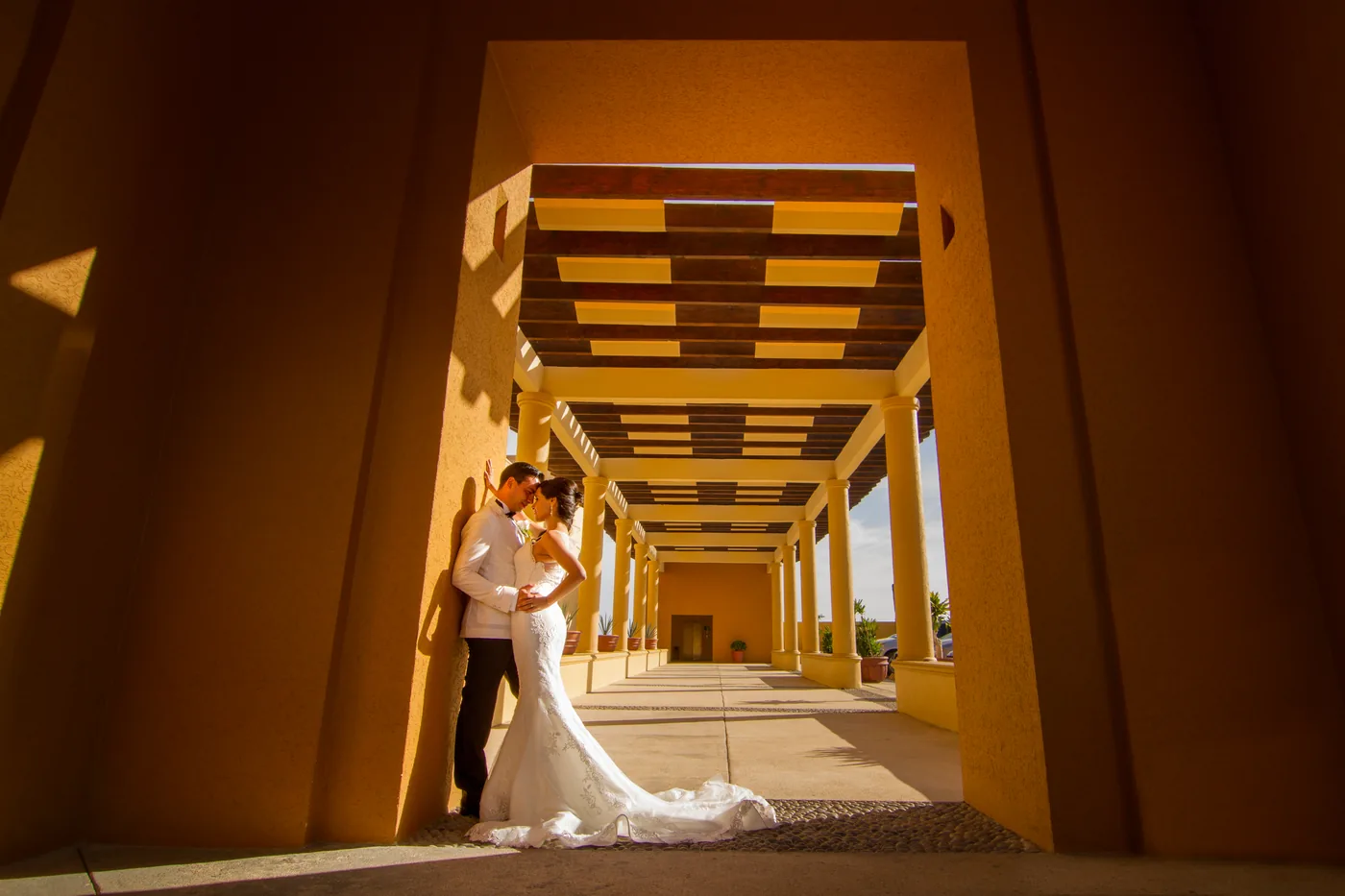 Bride and groom walking through the corridor at Fiesta Americana Los Cabos