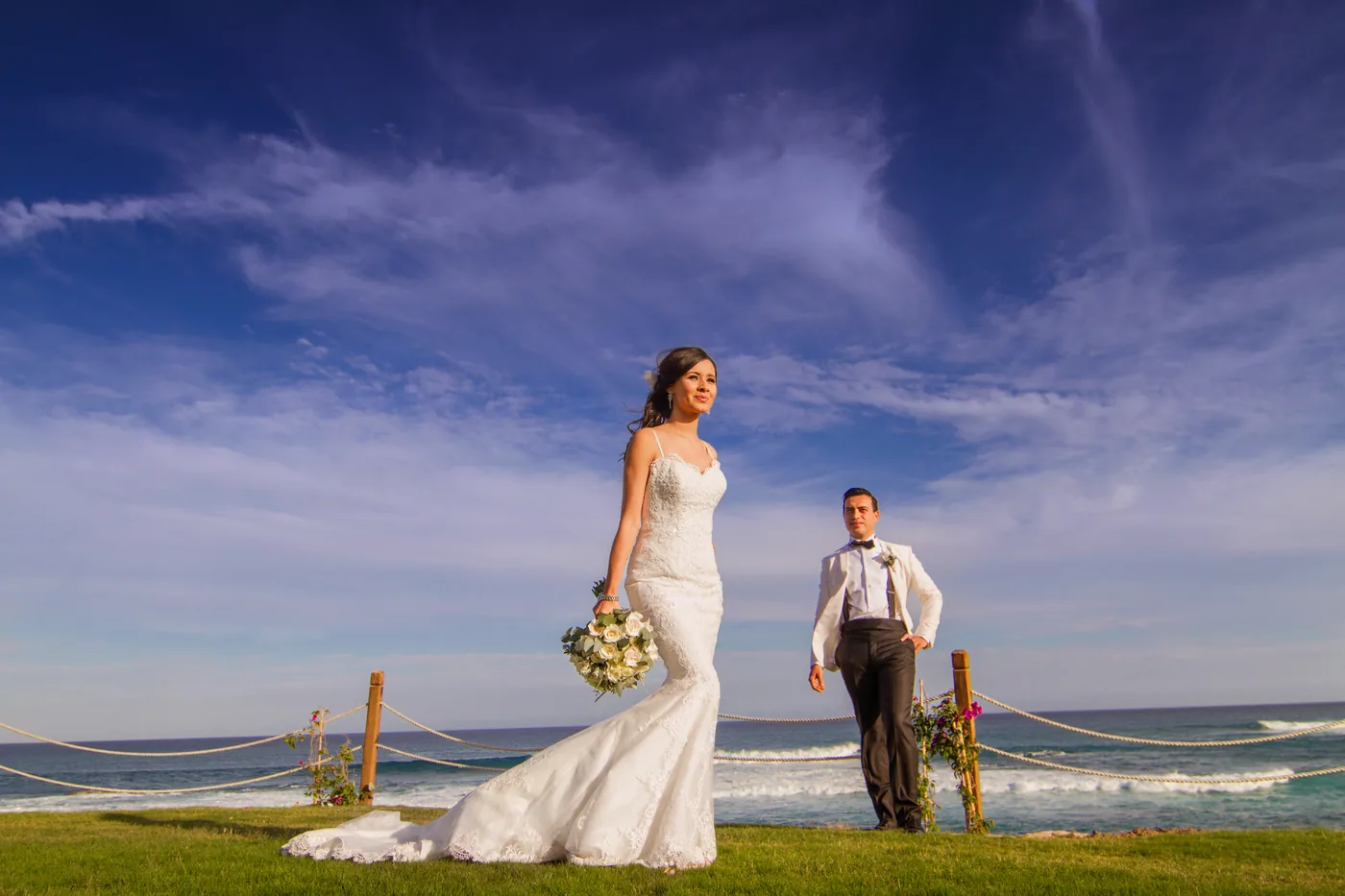 Couple on the lawn with the ocean behind at Fiesta Americana Los Cabos