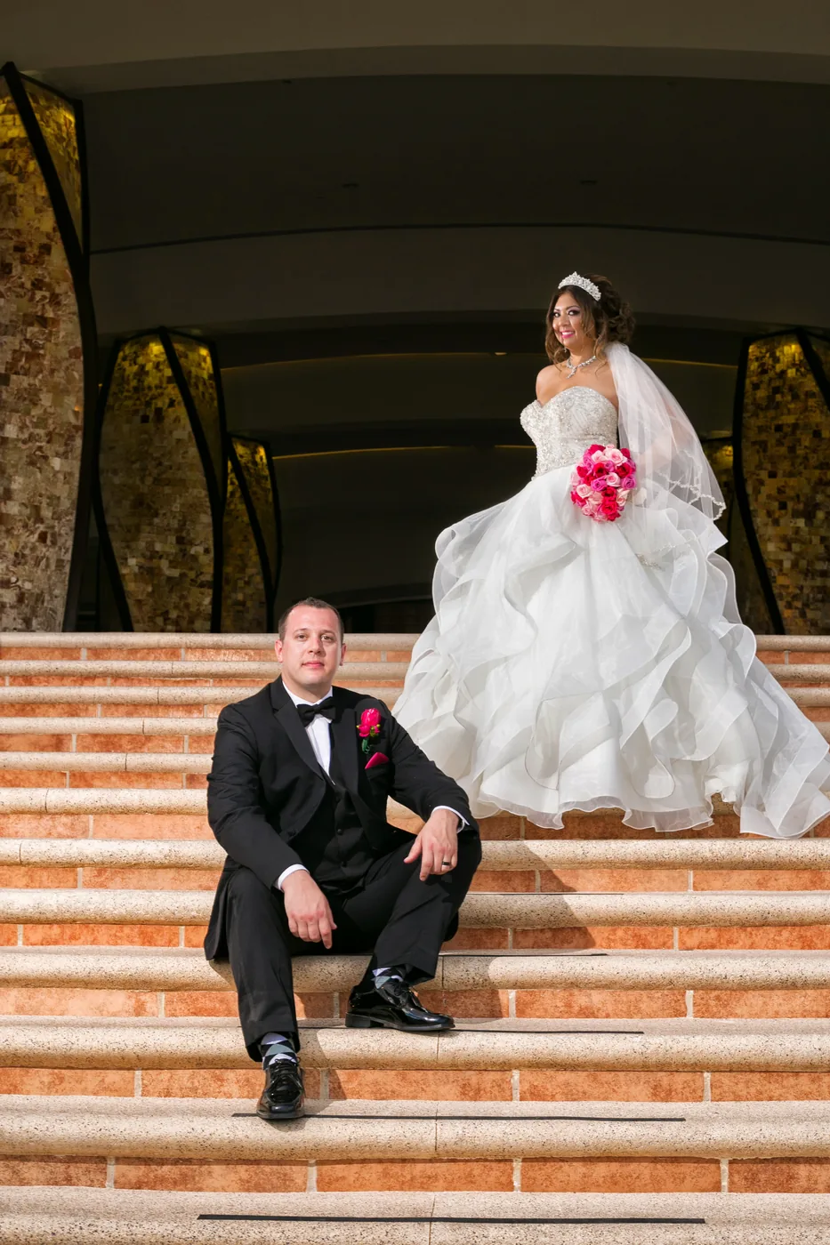 Bride and groom on the steps at Hyatt Ziva Los Cabos