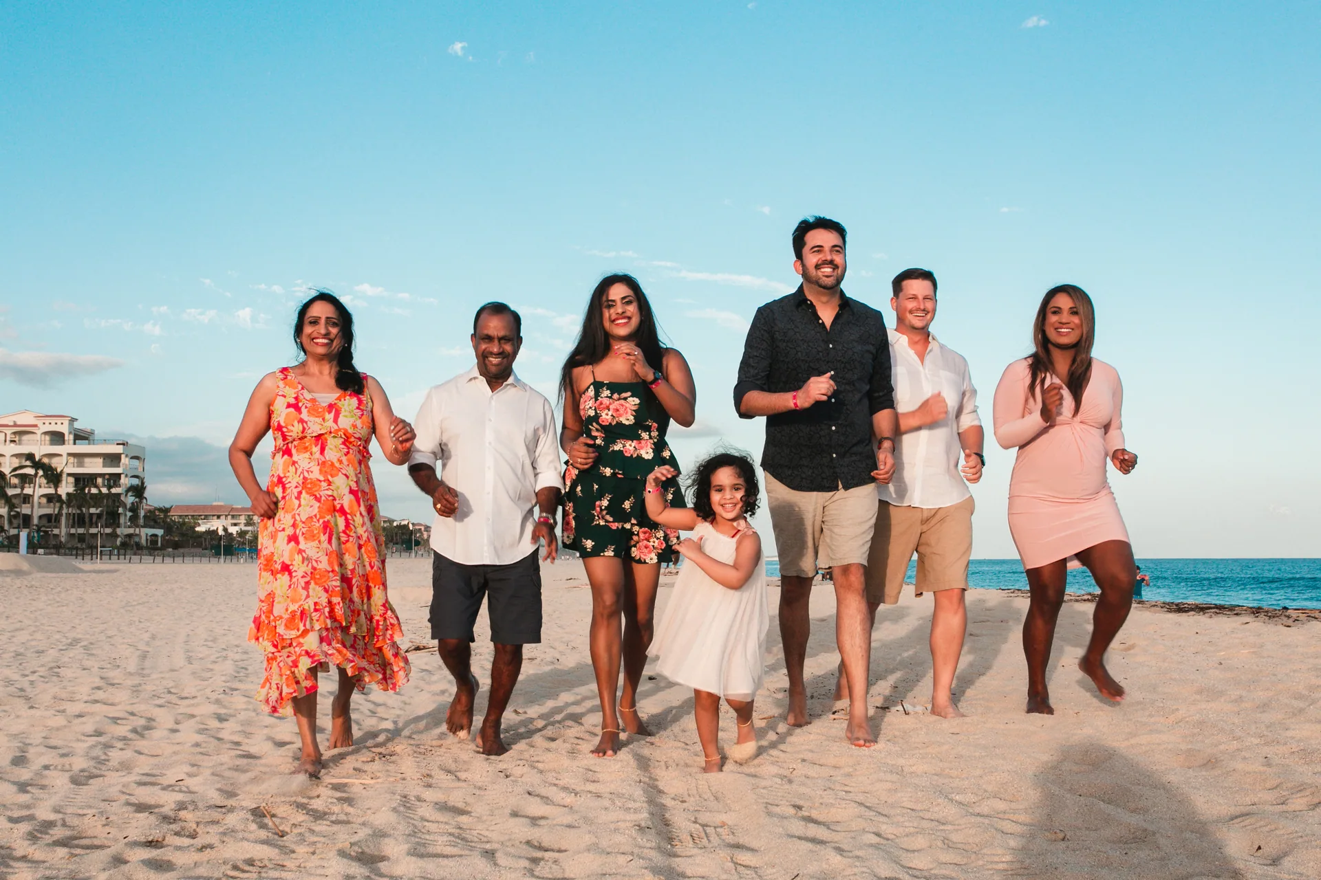 Extended family walking together on the beach in Los Cabos