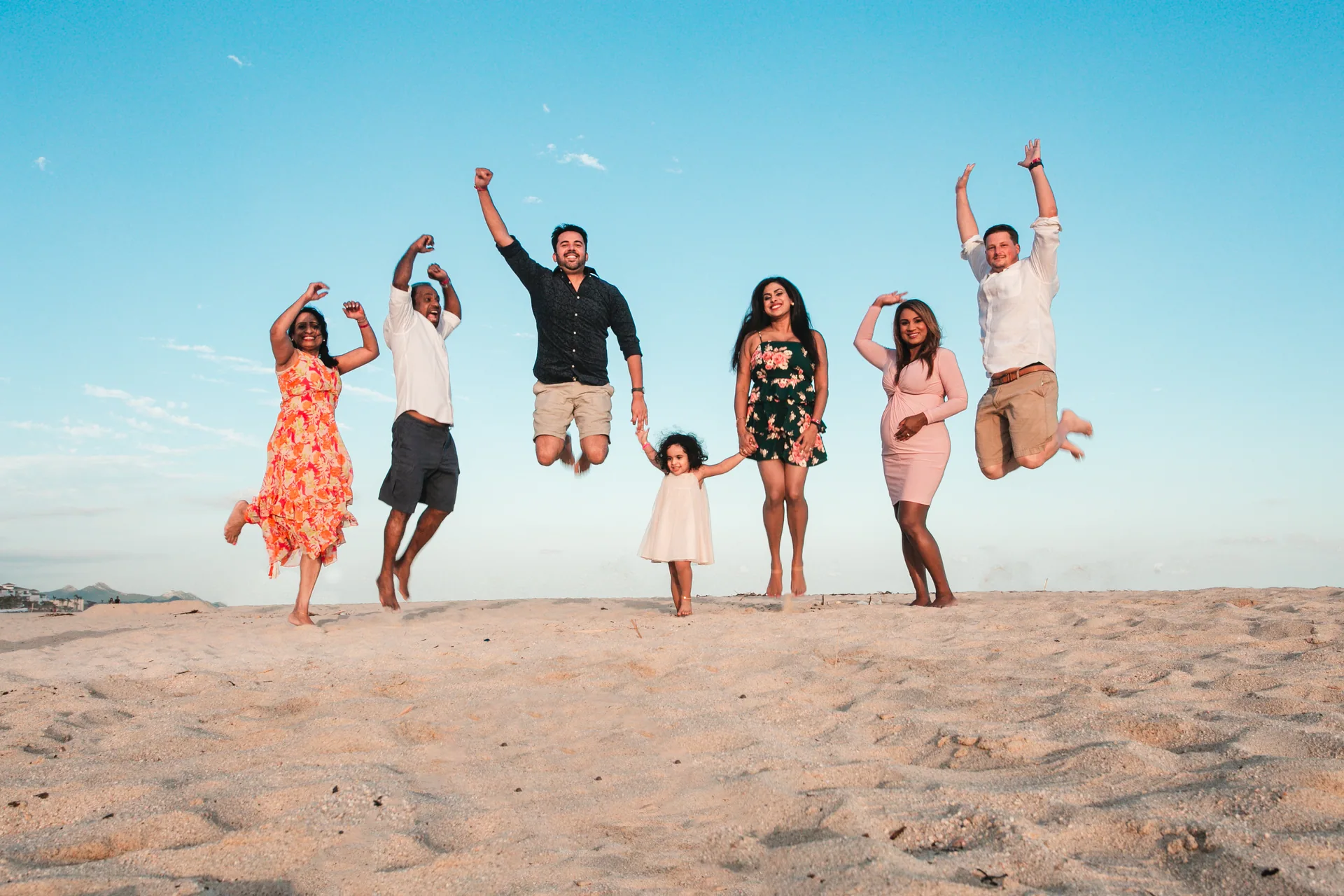 Family jumping for a photo on the beach at Hyatt Ziva Los Cabos