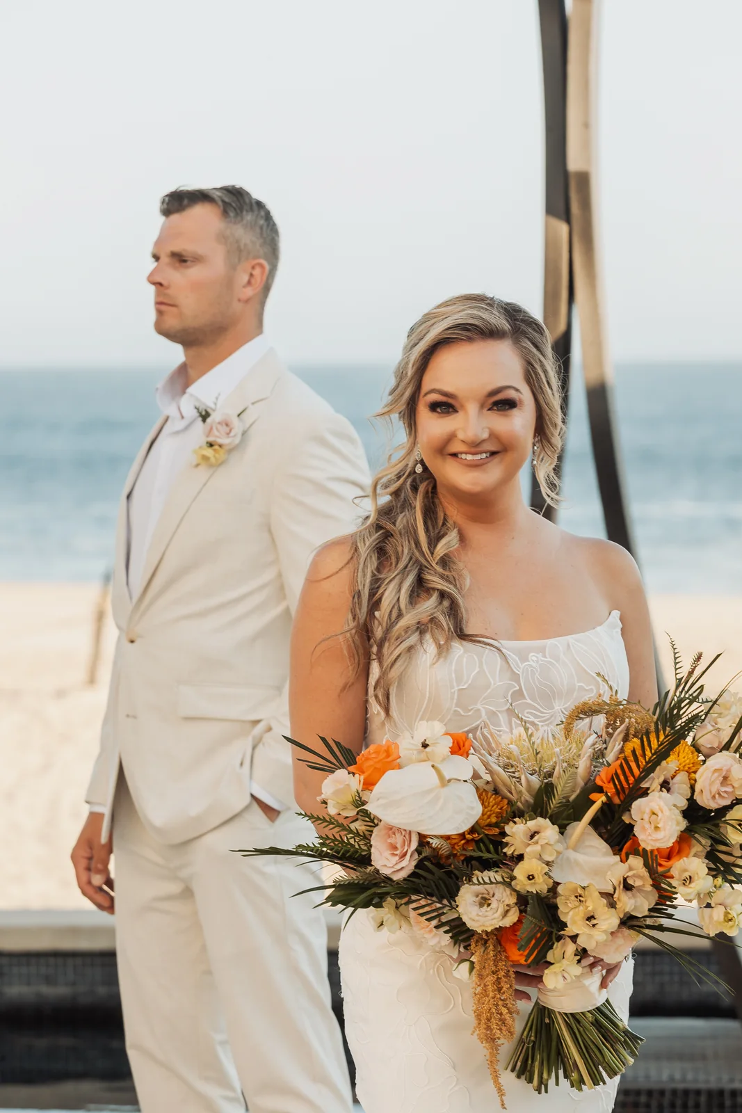 Bride and groom dressed in white on the beach at Pueblo Bonito Pacífica, Cabo San Lucas