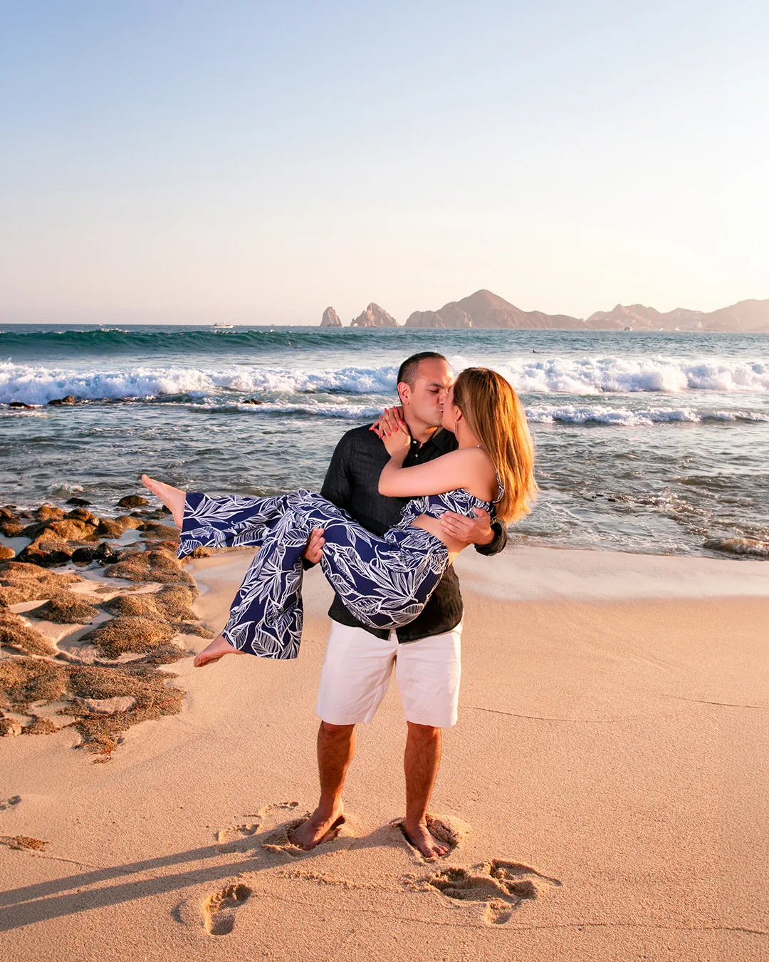 Couple at Playa Monumentos in Cabo San Lucas with El Arco in the background by Ana Badillo Photography