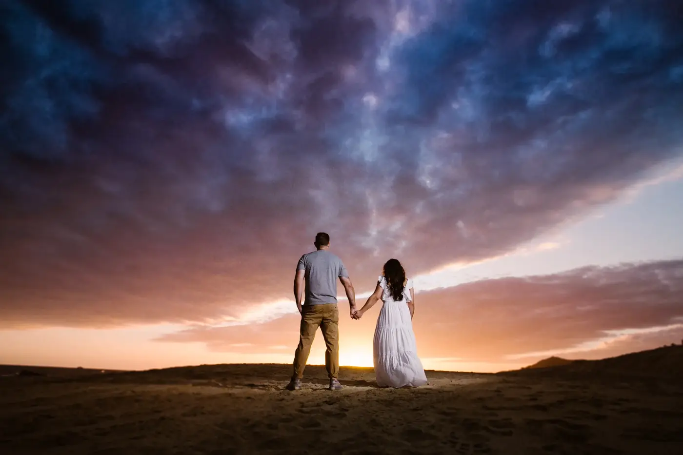Couple holding hands at sunset, Cabo San Lucas engagement photography