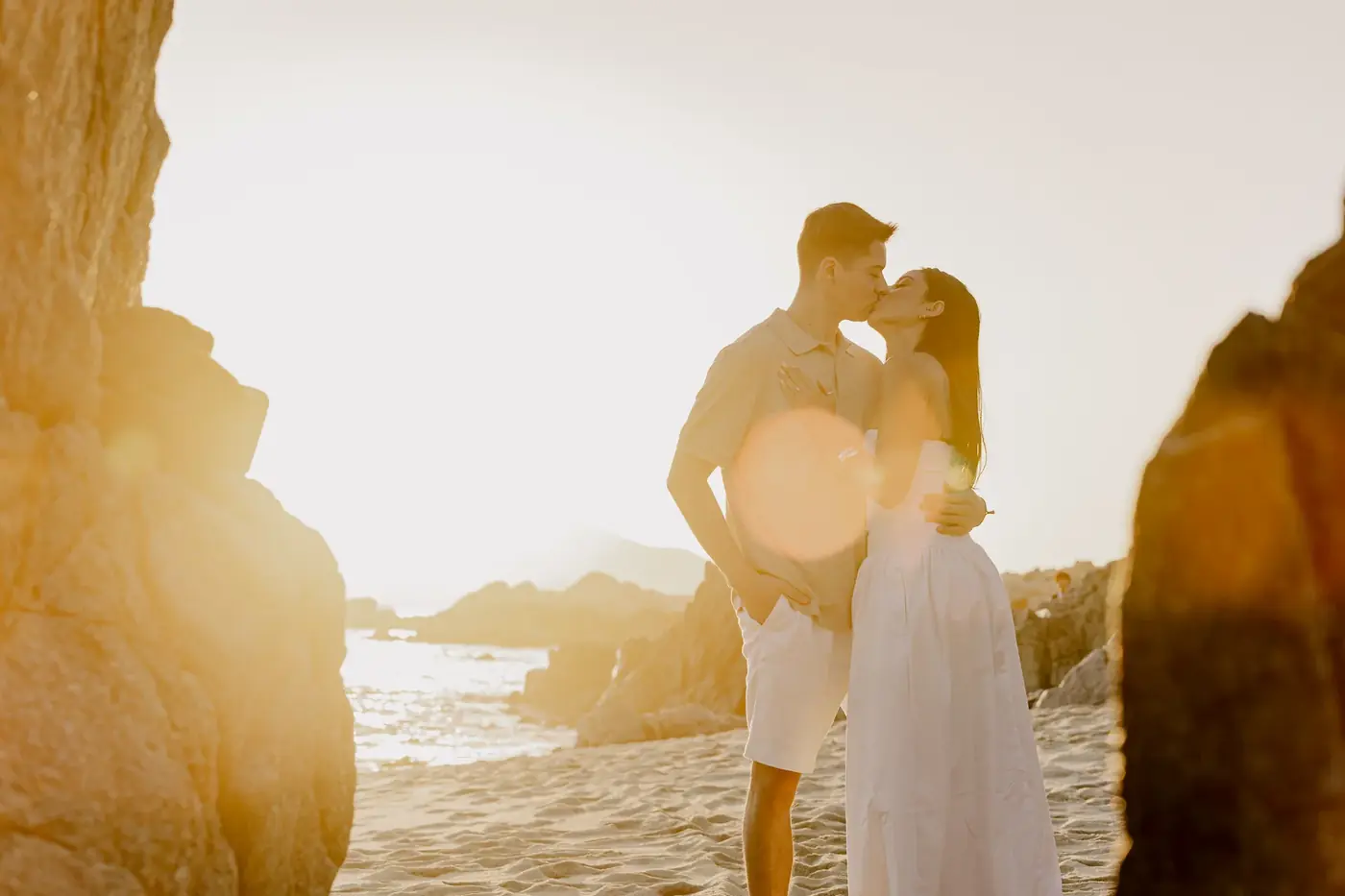 Couple backlit by the sun on the beach, Cabo San Lucas engagement