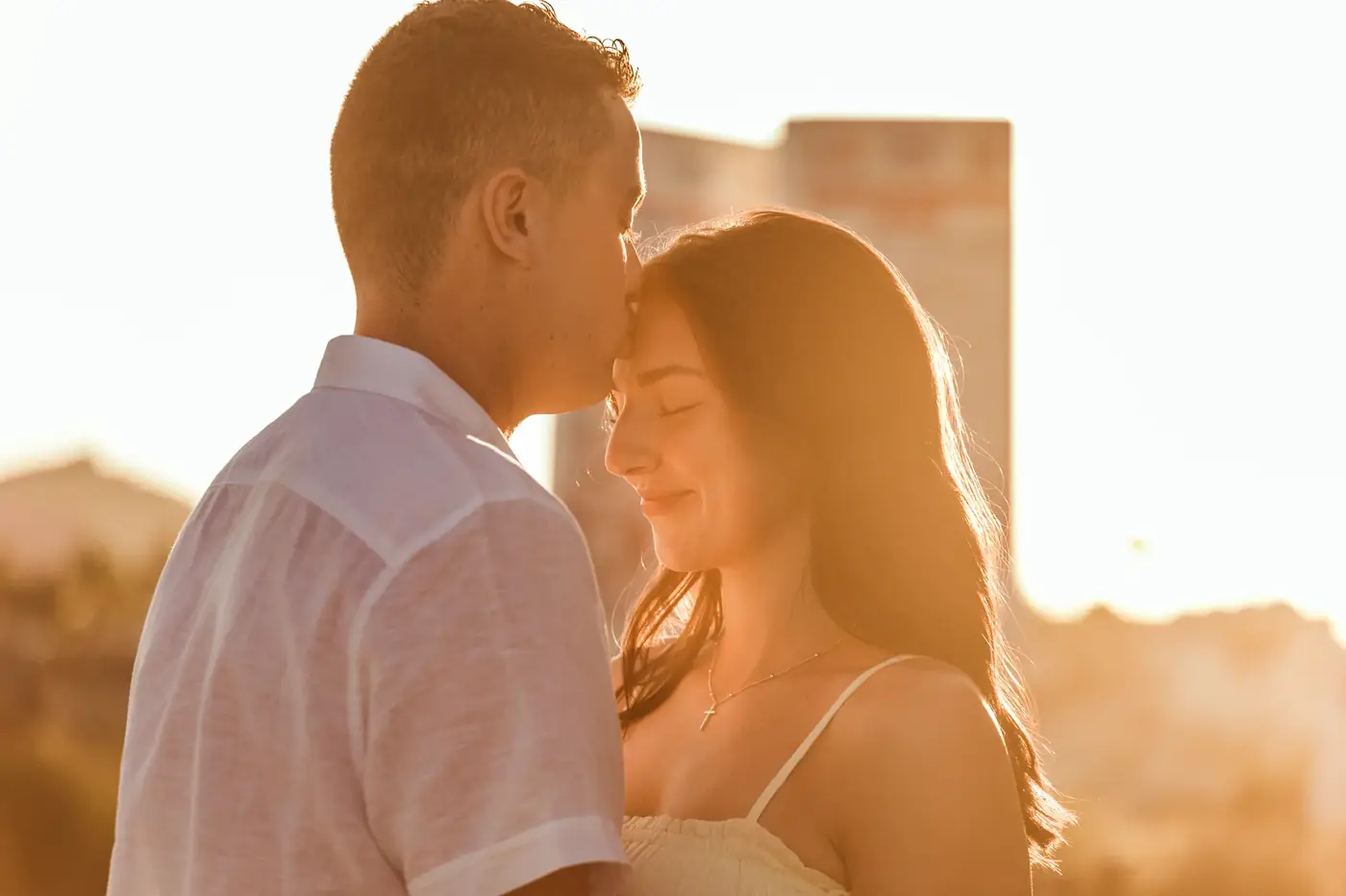 Couple embracing in warm golden light during a session in Cabo San Lucas