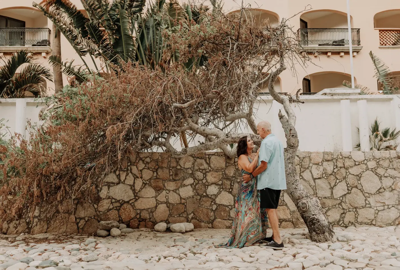Couple at El Arco in golden hour during a proposal in Cabo San Lucas, photographed by Ana Badillo