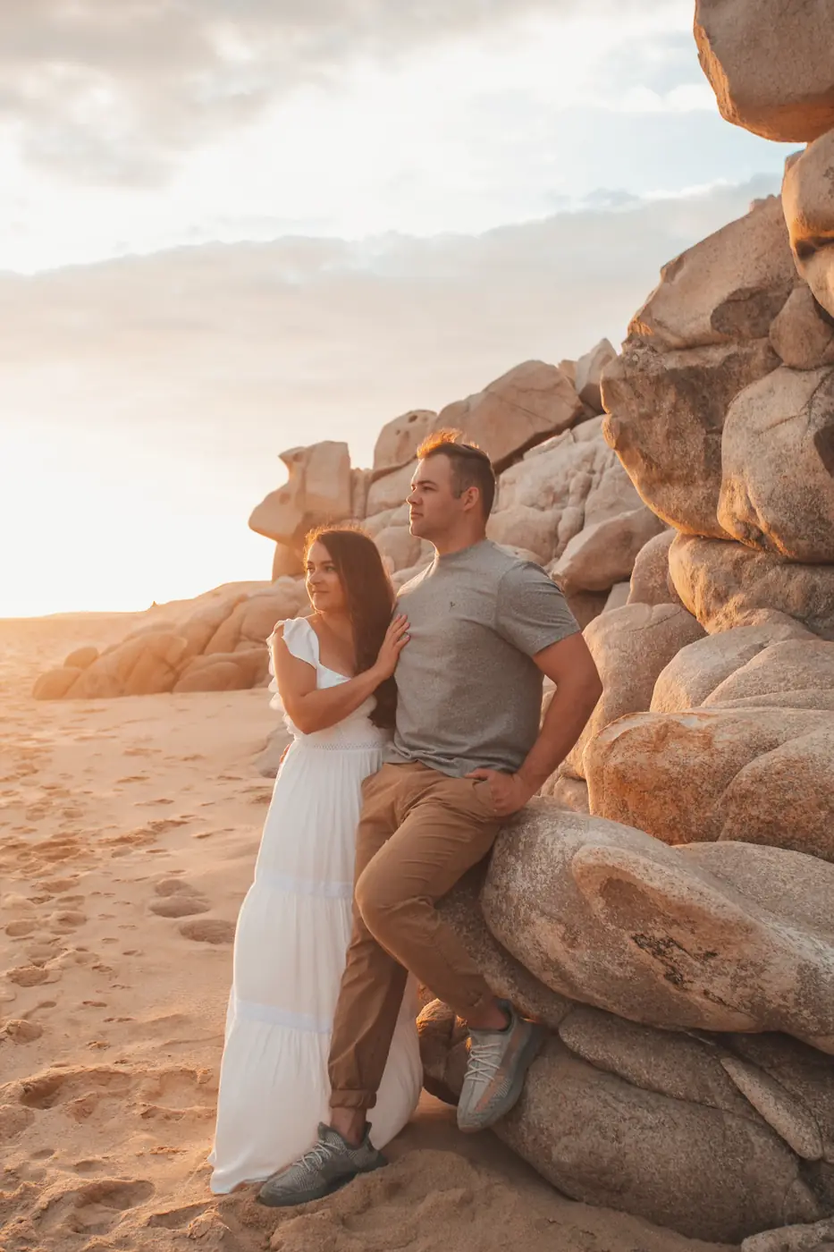 Couple walking on the beach at sunset in Los Cabos