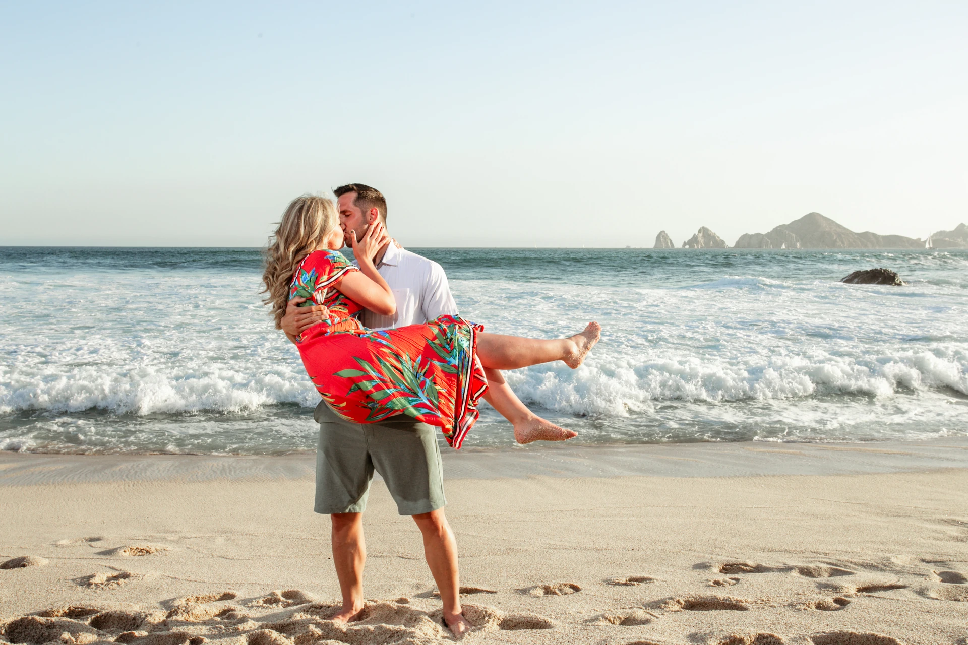 Couple laughing on the beach at Playa Monumentos in Cabo San Lucas