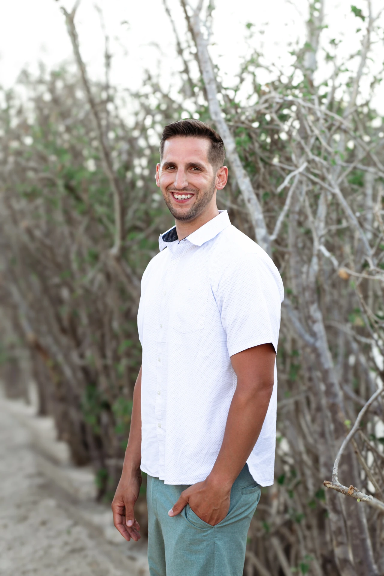 Portrait of a man in a white linen shirt during a couples session on the Sea of Cortez side of Cabo San Lucas