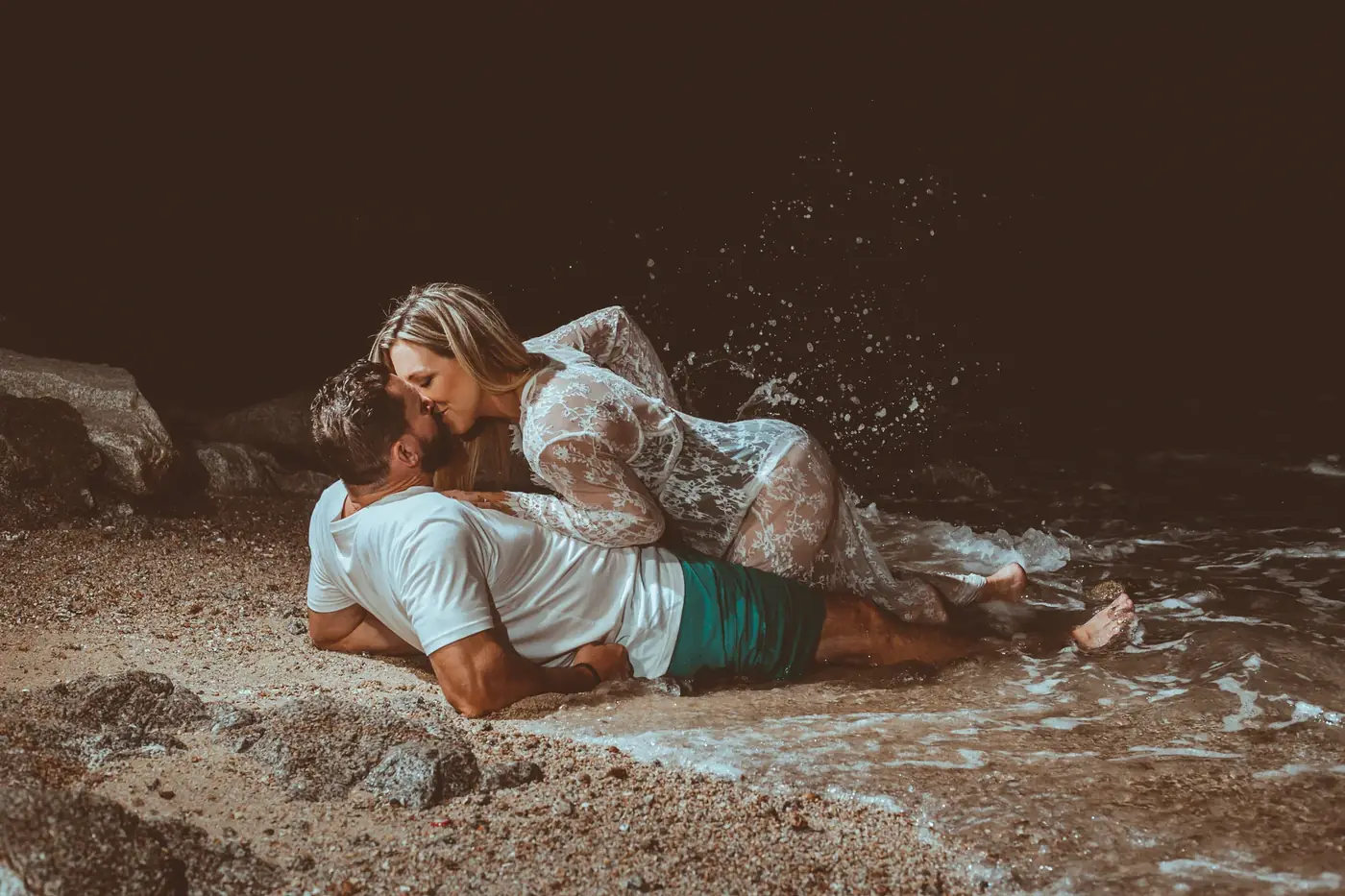 Couple laughing together on the rocks in Los Cabos