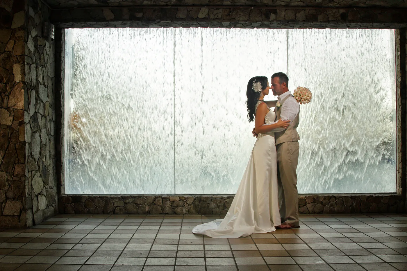 Bride and groom by the window at RIU Palace Cabo San Lucas