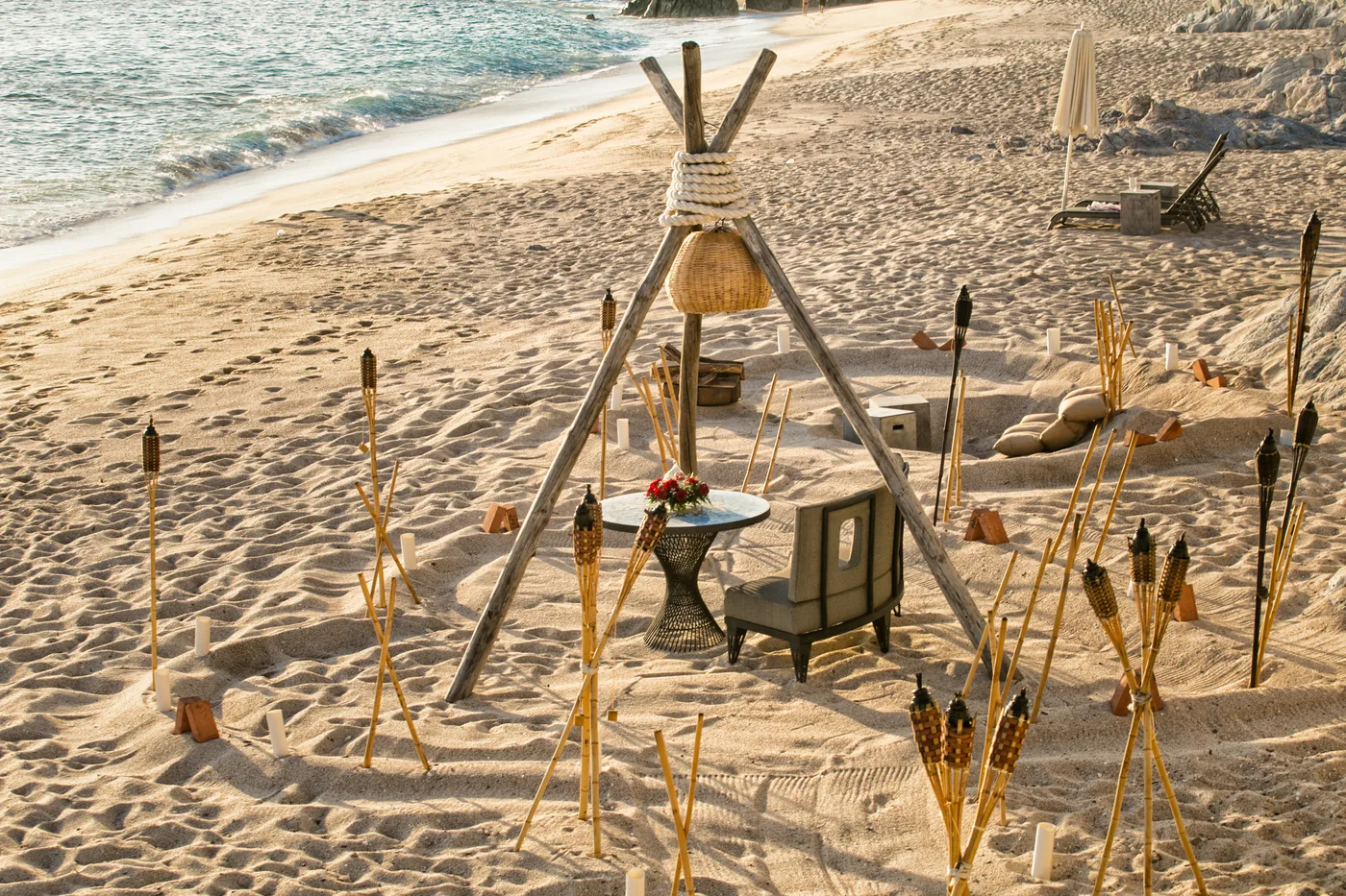 Romantic teepee dinner setup on the sand at The Cape Thompson Hotel in Cabo